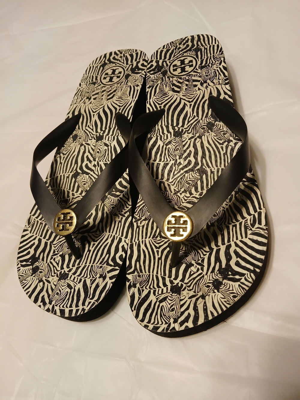Tory Burch Ladies Black Zebra Flip Flops with Gold Logo